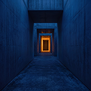 Minimalist concrete corridor with warm light, representing the ambient artist Sleep Passage.
