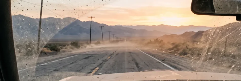 Dusty desert highway at sunset for Highway Lantern's Dust Never Sleeps